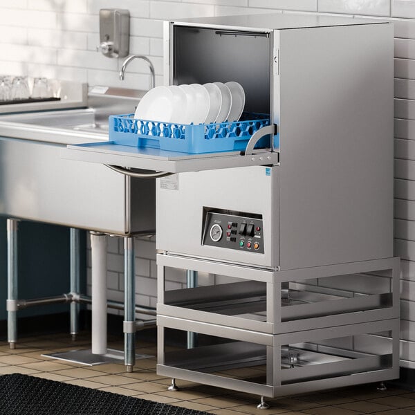 A Noble Warewashing undercounter dishwasher on a counter with plates inside.