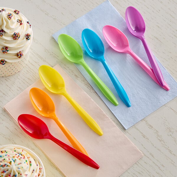A group of colorful Choice medium weight plastic spoons.