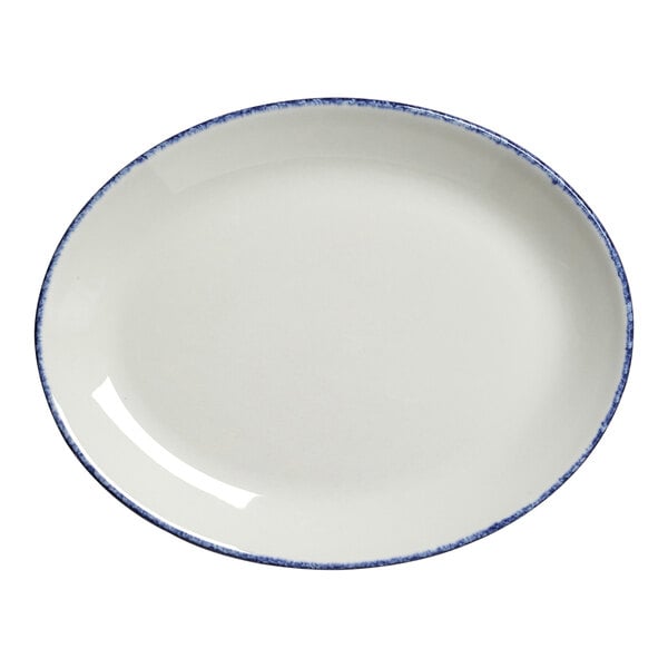 A close-up of a Steelite oval coupe platter with a white center and blue dapple design around the rim.