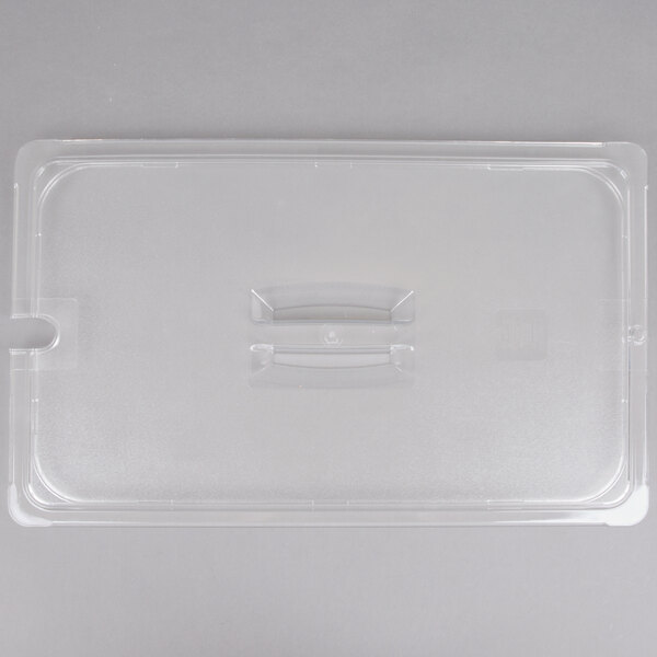 A clear rectangular plastic lid with a handle and a hole in the middle.