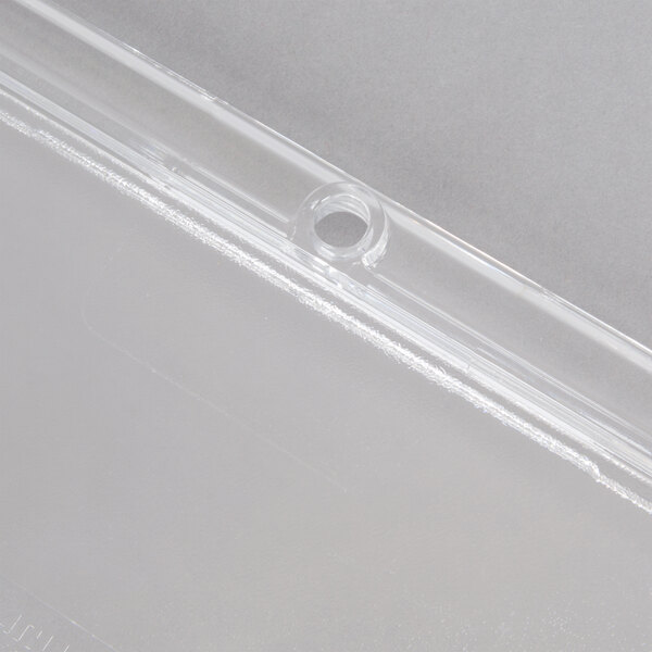 A clear plastic Carlisle StorPlus food pan lid with a spoon notch.