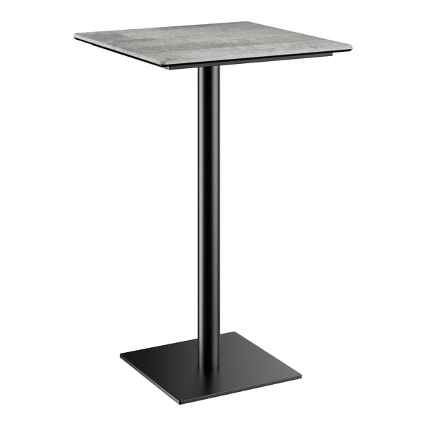 A Lancaster Table & Seating Excalibur bar height table with a square black base and textured gray square top.