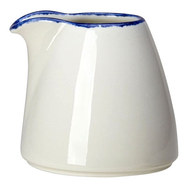 A white pitcher with blue trim on the side.