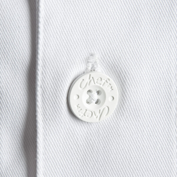 A close-up of a white button on a white Chef Revival chef jacket.