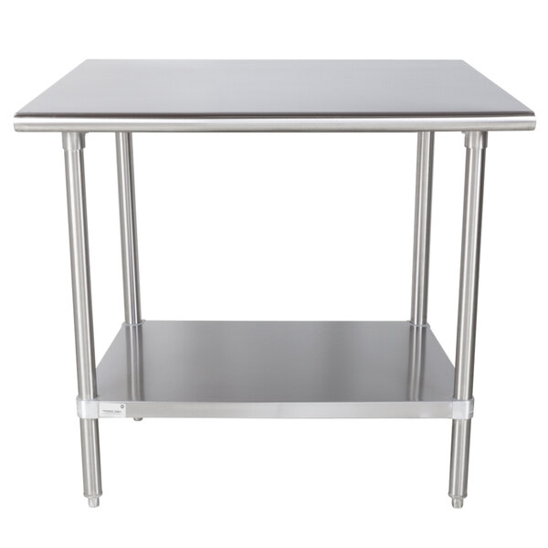 An Advance Tabco stainless steel work table with a shelf.