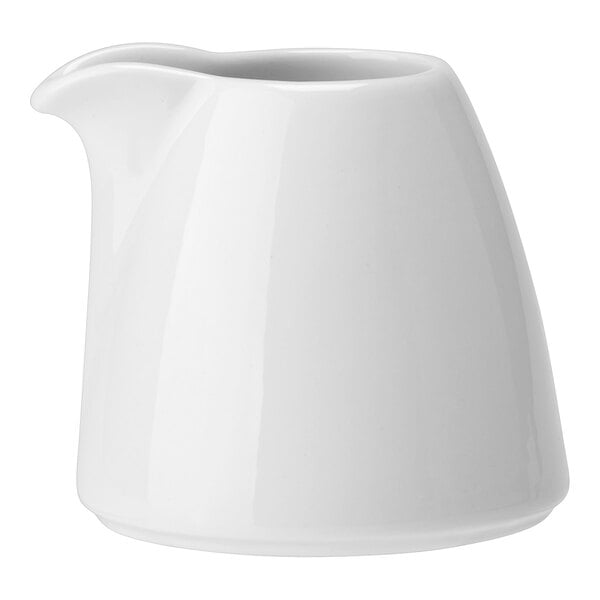 A white ceramic pitcher with no handle on a white background.