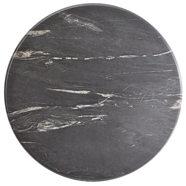 A Lancaster Table & Seating Excalibur round table top with a black and white marbled surface.