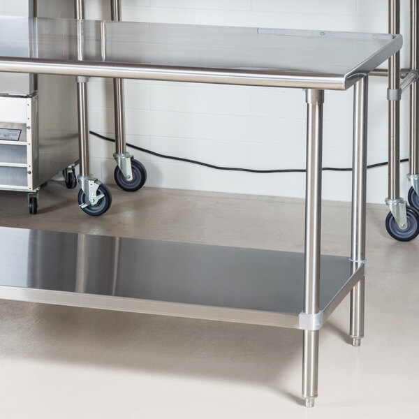 A stainless steel Advance Tabco work table with an undershelf.