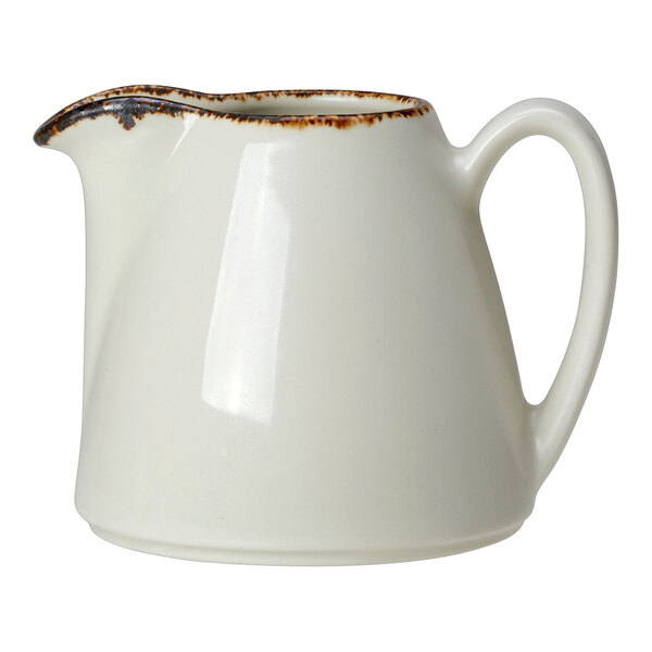 A white Steelite handled jug with brown specks.