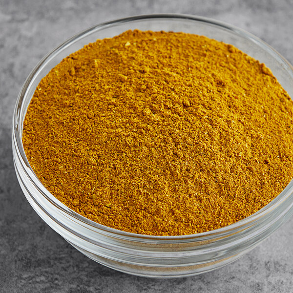 A bowl of Badia curry powder on a table.