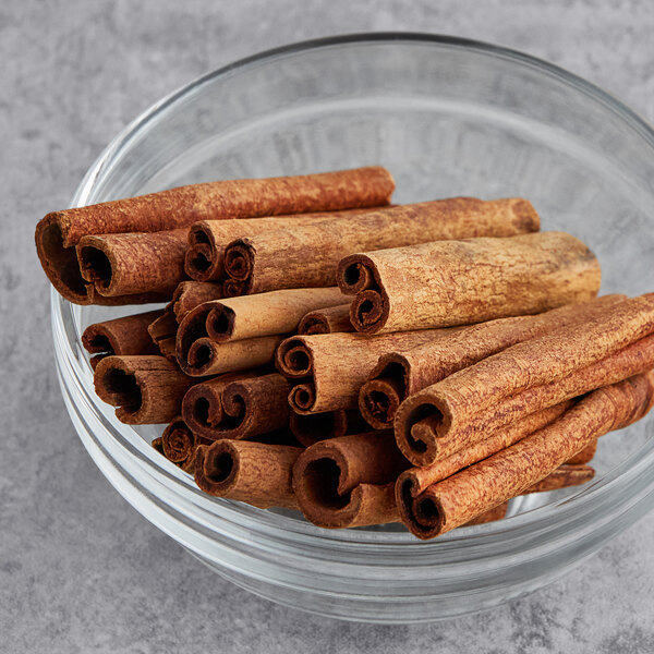 A glass bowl of Badia cinnamon sticks.