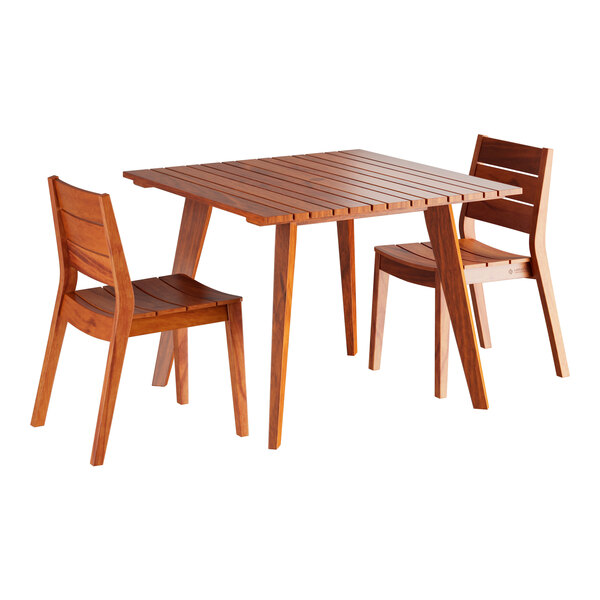 A Lancaster Table & Seating tigerwood table with two chairs.