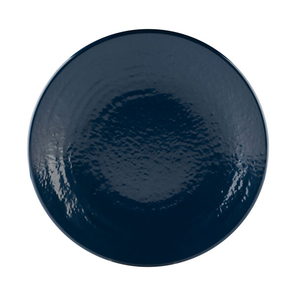 A white plate with a blue pebble textured rim.