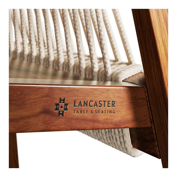 A Lancaster Table & Seating outdoor arm chair with nautical rope accents on the arms.