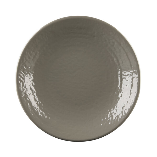 A close-up of an Elite Global Solutions Pebble Creek mushroom-colored plate with a white rim.