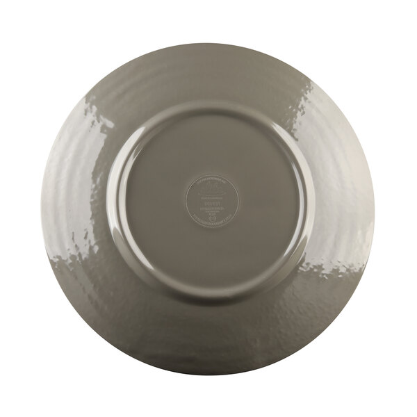 A close-up of an Elite Global Solutions Pebble Creek mushroom-colored round plate with a silver rim.