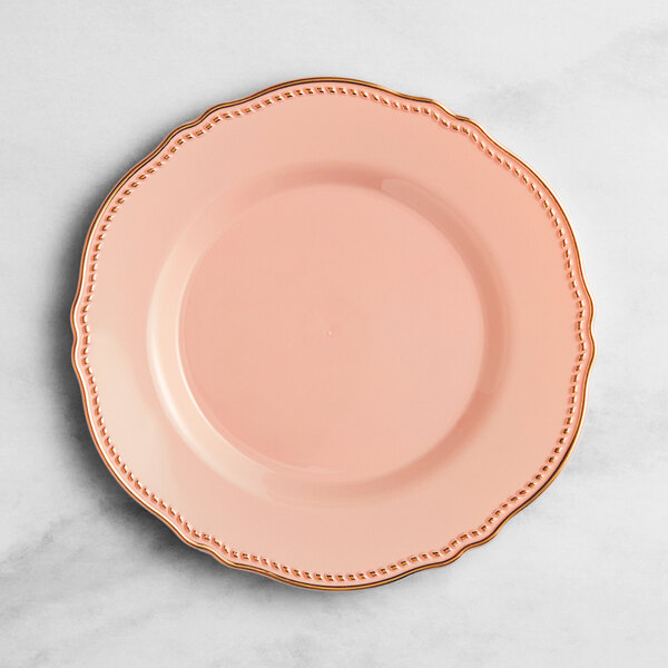A Visions blush plastic plate with gold vintage trim.