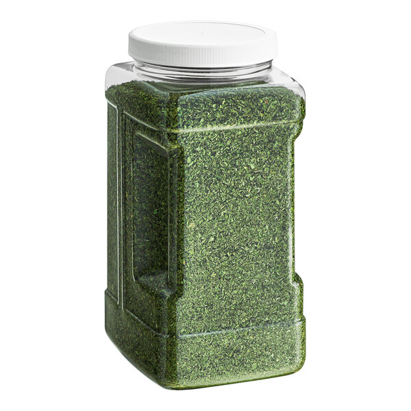 A large green container of Badia Parsley Flakes with a lid.