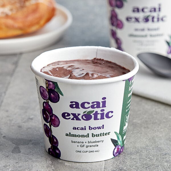 A cup of Acai Exotic Almond Butter on a table.