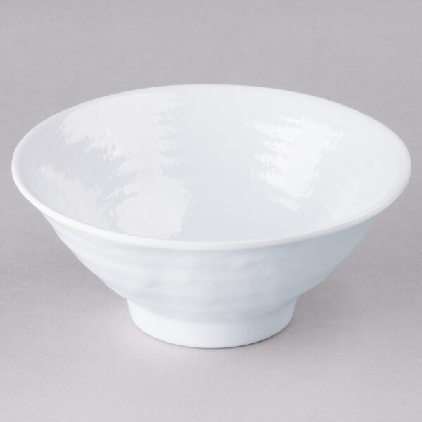 A white Elite Global Solutions Pebble Creek bowl with a white rim on a gray surface.