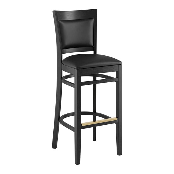 A Lancaster Table & Seating Sofia black wood bar stool with a black vinyl seat.