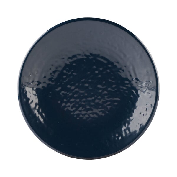 A close-up of the textured blue surface of an Elite Global Solutions Pebble Creek Lapis-Colored round plate.