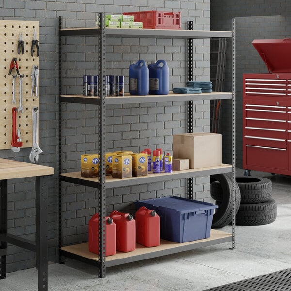 A black heavy-duty four-shelf boltless particle board shelving unit with 84-inch uprights, used for garage or workshop storage.