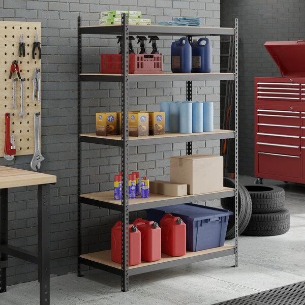 A black heavy-duty five-shelf boltless particle board shelving unit with 84-inch uprights, used for storage in a garage or workshop.