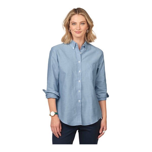 A women's light blue long sleeve oxford dress shirt with a button-down front and a chest pocket.