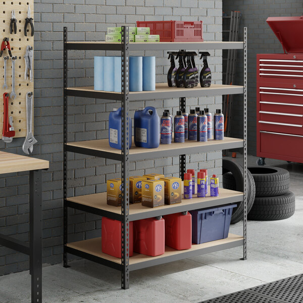 A black heavy-duty five-shelf boltless particle board shelving unit with 72-inch uprights, used for organized storage in a garage or workshop.