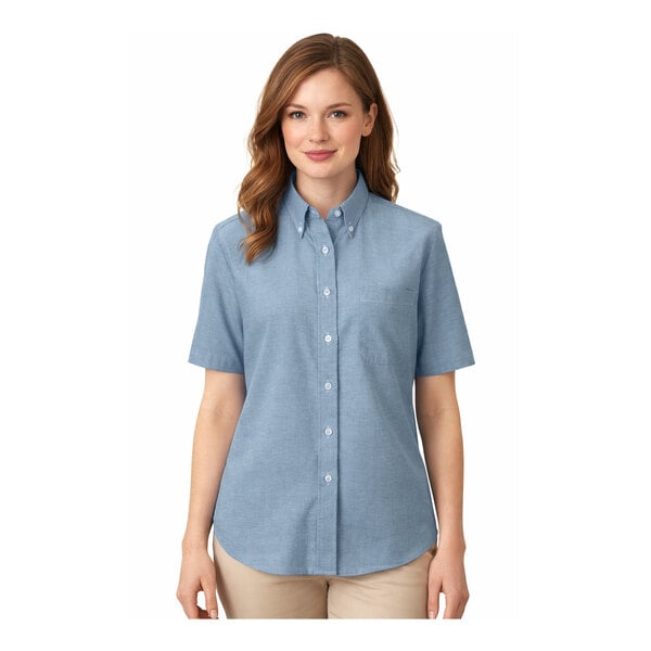 A women's medium blue short sleeve button-up oxford dress shirt with a front pocket.