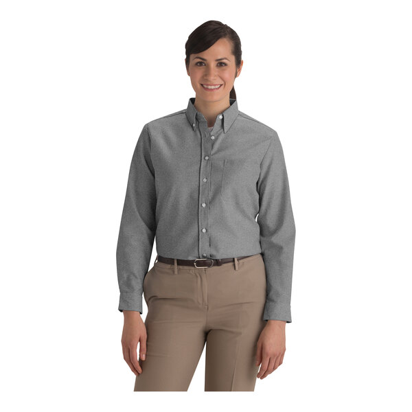A women's gray long sleeve button-up oxford dress shirt paired with khaki pants.