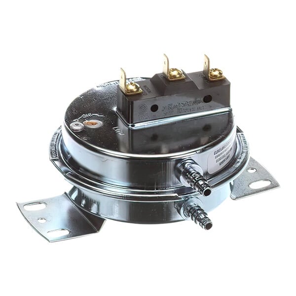 A close-up of a Wells vacuum switch with two metal wires.
