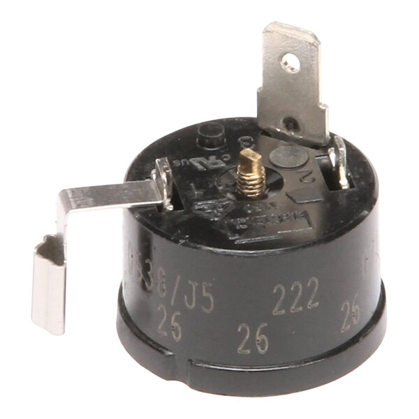 A small black round Scotsman overload device with a metal plate.