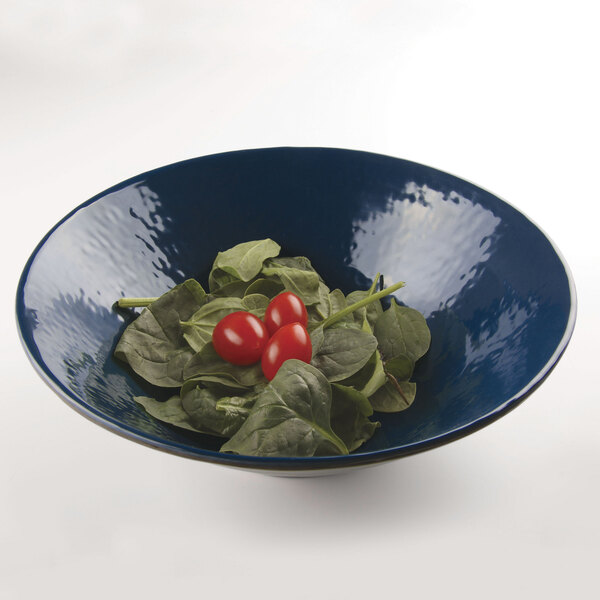 A lapis-colored Elite Global Solutions melamine bowl filled with spinach and tomatoes.