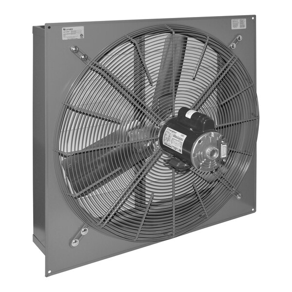 A large industrial wall-mounted exhaust fan with a protective metal grille and three blades.