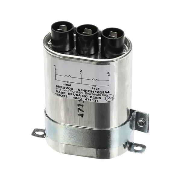 A silver TurboChef capacitor with black and white text and three wires.