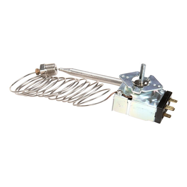 A Wells metal thermostat with a wire coil.