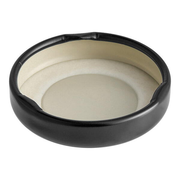 A black metal lid with a white plastisol liner.