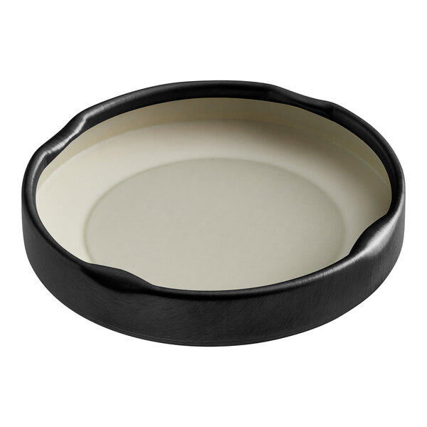 A white plate with a black circular object on it.