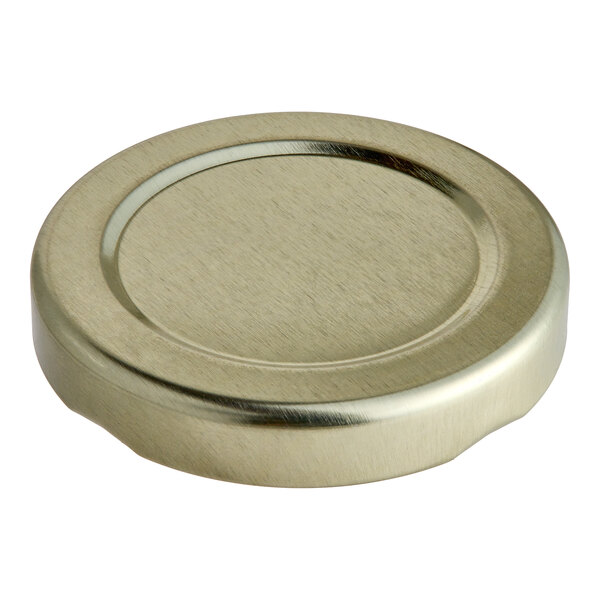 A gold metal lid with a circular top.