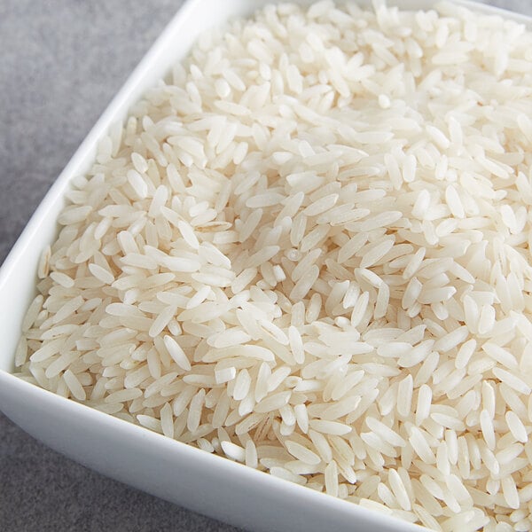A white bowl filled with Riceland Extra-Long Grain Enriched White Rice.