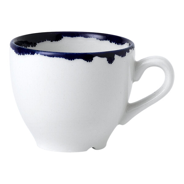 A white espresso cup with a blue ink design and handle.
