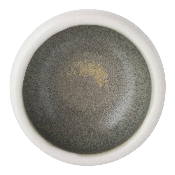 A close up of a white Bon Chef Tavola ramekin with a speckled design.