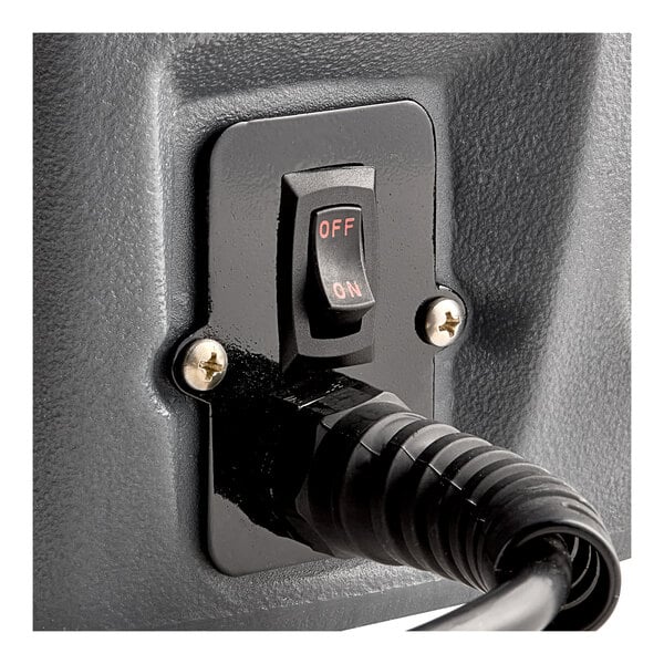 A close-up of a black and white switch on a Lavex cold water spot extractor.