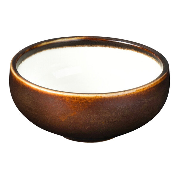 A brown Bon Chef ramekin with a white rim.