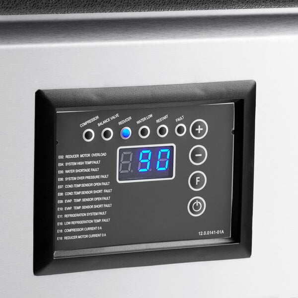 A digital control panel with a blue LED display, several indicator lights, and labeled buttons, set in a stainless steel surface.