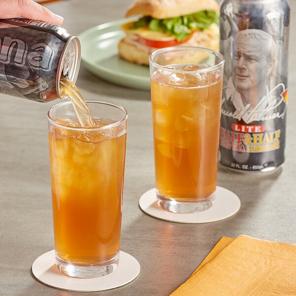 A person pouring AriZona Arnold Palmer Lite Half and Half Iced Tea Lemonade from a can into a glass