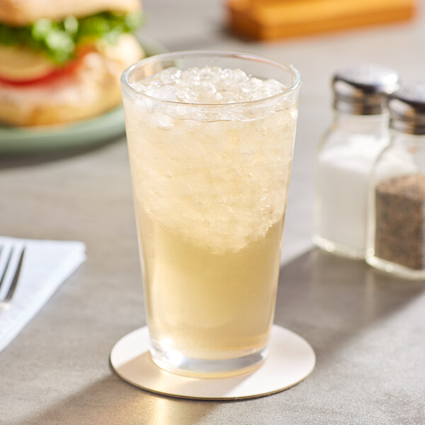 A glass of AriZona Green Tea with ice on a table.