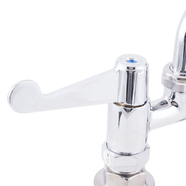 A chrome Equip by T&S deck-mounted faucet with wrist handles and a swing spout.